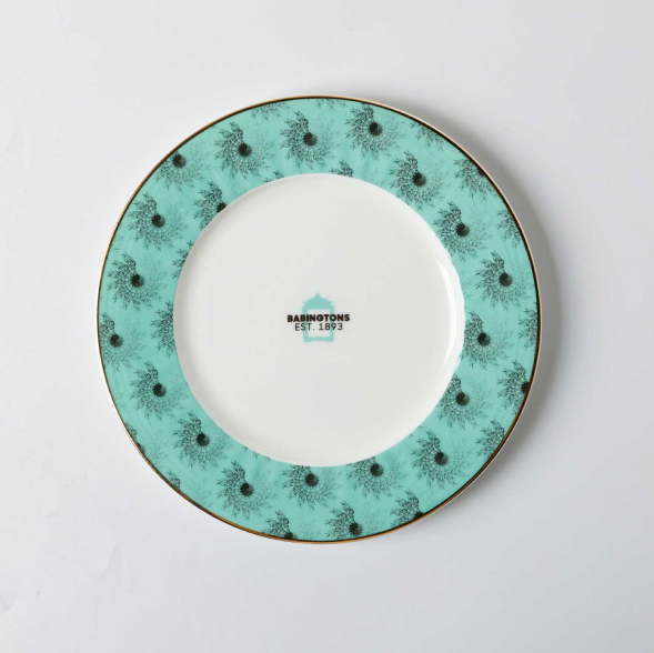Turquoise rimmed plate with black and white pattern